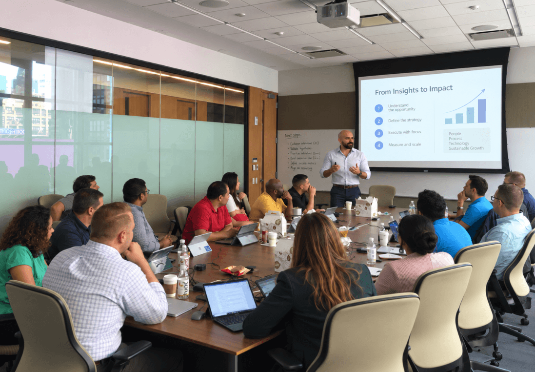 A facilitator presents a business roadmap to a team gathered around a conference table.
